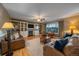 Spacious living room with built-in shelving, fireplace, and hardwood floors at 2776 Savage Rd, Elizabeth, CO 80107