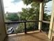Charming balcony view with lush greenery and a secure black railing at 7355 S Alkire St # 203, Littleton, CO 80127