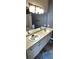 Bathroom featuring a double vanity sink with a large mirror at 7355 S Alkire St # 203, Littleton, CO 80127