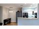 Contemporary dining area with piano, gray cabinets, breakfast bar, and view into kitchen at 7355 S Alkire St # 203, Littleton, CO 80127
