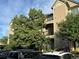 View of the exterior of the building featuring balconies and a well-maintained landscape at 7355 S Alkire St # 203, Littleton, CO 80127