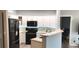 Open concept kitchen with sleek black appliances and white cabinetry at 7355 S Alkire St # 203, Littleton, CO 80127