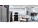 Modern kitchen with white cabinets and black appliances at 7355 S Alkire St # 203, Littleton, CO 80127