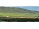 View of the green rolling hills and landscape of the surrounding area from the property at 7355 S Alkire St # 203, Littleton, CO 80127