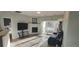 Cozy living room features a fireplace, wood floors, and sliding doors to a balcony at 7355 S Alkire St # 203, Littleton, CO 80127