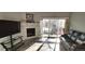 Bright living room featuring a fireplace and sliding doors to a balcony at 7355 S Alkire St # 203, Littleton, CO 80127