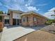 A concrete patio is surrounded by brick and siding home exteriors and rock landscaping at 3810 Urban St, Wheat Ridge, CO 80033