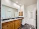 A spacious bathroom featuring a double sink vanity, marble floors, and updated fixtures at 3810 Urban St, Wheat Ridge, CO 80033