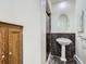Pedestal sink with a large mirror and shower in a tiled bathroom at 3810 Urban St, Wheat Ridge, CO 80033