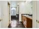 A spacious bathroom featuring double vanity, marble floors, a soaking tub and custom fixtures at 3810 Urban St, Wheat Ridge, CO 80033