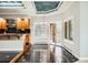 Bright eat-in kitchen with black marble floors and countertops and a chandelier over the dining area at 3810 Urban St, Wheat Ridge, CO 80033