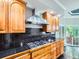 Modern kitchen featuring stainless steel range hood, gas cooktop, black backsplash and custom cabinets at 3810 Urban St, Wheat Ridge, CO 80033