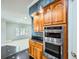 A gourmet kitchen features stainless steel KitchenAid appliances and custom cabinets and countertops at 3810 Urban St, Wheat Ridge, CO 80033
