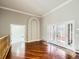 Spacious room with crown molding, hardwood flooring, and French doors opening to an outdoor area at 3810 Urban St, Wheat Ridge, CO 80033