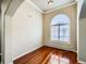 Bright room with hardwood floors, crown molding, a large arched window, and neutral wall color at 3810 Urban St, Wheat Ridge, CO 80033