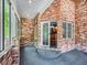 A cozy brick-walled patio features elegant glass doors with a glimpse of the kitchen interior at 3810 Urban St, Wheat Ridge, CO 80033