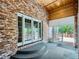 A brick patio features wooden ceilings and glass doors that bring the outside in for year-round relaxation at 3810 Urban St, Wheat Ridge, CO 80033