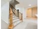 A carpeted staircase with decorative wood banisters leads to a finished basement or second floor at 3810 Urban St, Wheat Ridge, CO 80033