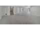 Spacious basement with neutral carpet offers a large open area with stairs and access to other rooms at 6054 W Adriatic Pl, Lakewood, CO 80227