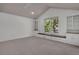 Bright bedroom features vaulted ceiling, built-in shelves, drawers, window seat offering storage, and a cozy reading nook at 6054 W Adriatic Pl, Lakewood, CO 80227