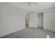 Bright bedroom with neutral carpet and walls offers a clean and versatile space with ample closet storage at 6054 W Adriatic Pl, Lakewood, CO 80227