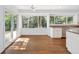 Bright dining area with hardwood floors, large windows, and a sliding door creating an inviting and airy space at 6054 W Adriatic Pl, Lakewood, CO 80227