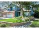 Charming two-story home with brick and blue siding, a well-manicured lawn, and mature landscaping enhancing curb appeal at 6054 W Adriatic Pl, Lakewood, CO 80227