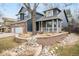 Well-maintained two-story home featuring brick, lush landscaping, and curb appeal at 6054 W Adriatic Pl, Lakewood, CO 80227