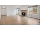 Modern living room showcasing a fireplace, natural lighting, and neutral walls at 6054 W Adriatic Pl, Lakewood, CO 80227