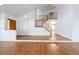 Open living area with hardwood floors, natural light, staircase, and a seamless transition to other living spaces at 6054 W Adriatic Pl, Lakewood, CO 80227