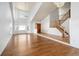 Bright living room featuring hardwood floors, vaulted ceilings, large windows, and an open floor plan at 6054 W Adriatic Pl, Lakewood, CO 80227