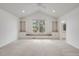 Spacious main bedroom with large window seat flanked by bookshelves, vaulted ceiling and fan at 6054 W Adriatic Pl, Lakewood, CO 80227