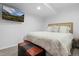 Finished basement featuring a cozy bedroom setup with a comfortable bed and mounted TV for entertainment at 5944 S Yank Ct, Littleton, CO 80127