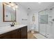 Bright bathroom features wood-look floors, a glass enclosed shower and updated vanity at 5944 S Yank Ct, Littleton, CO 80127