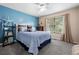 Stylish bedroom features blue walls, plush carpet, and a nicely decorated bed at 5944 S Yank Ct, Littleton, CO 80127