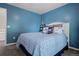 Stylish bedroom features blue walls, plush carpet, and a nicely decorated bed at 5944 S Yank Ct, Littleton, CO 80127