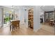 Charming dining area with display cabinet, drop leaf table, and an adjoining living room with a fireplace at 5944 S Yank Ct, Littleton, CO 80127