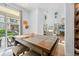 Open-concept dining area with a table and access to the outdoor patio and views of the backyard at 5944 S Yank Ct, Littleton, CO 80127