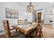 Dining room with wood table and chairs, decorative chandelier, and view of the staircase at 5944 S Yank Ct, Littleton, CO 80127