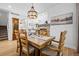 Dining room featuring a wood table, chandelier lighting, and a view into the living room and fireplace at 5944 S Yank Ct, Littleton, CO 80127