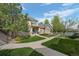 Beautiful two-story home featuring a well-maintained lawn, stone accents, and inviting front porch with walkway at 5944 S Yank Ct, Littleton, CO 80127