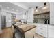 Kitchen showcases white cabinetry, stainless steel appliances, and an island with seating at 5944 S Yank Ct, Littleton, CO 80127