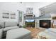 Cozy living room featuring a fireplace, comfortable seating, and bright natural light at 5944 S Yank Ct, Littleton, CO 80127