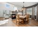 Living room and dining area with fireplace, wood floors, and ample natural light at 5944 S Yank Ct, Littleton, CO 80127