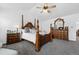 Elegant main bedroom with a four-poster bed, ceiling fan, and traditional-style dresser and nightstands at 5944 S Yank Ct, Littleton, CO 80127