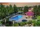 Community pool with lounge chairs, a covered gazebo, and lush landscaping against a scenic sunset at 5944 S Yank Ct, Littleton, CO 80127