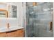 Bathroom featuring a modern sink and vanity next to a glass shower with gray tiles at 142 High Point Dr, Breckenridge, CO 80424