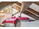 Bedroom with two beds with red plaid bedding, vaulted ceilings and exposed beams at 142 High Point Dr, Breckenridge, CO 80424