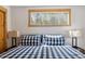 Bedroom with blue plaid comforter, wood trim window, and a pair of side table lamps at 142 High Point Dr, Breckenridge, CO 80424