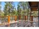 Spacious deck offering scenic views of tall pine trees and blue sky at 142 High Point Dr, Breckenridge, CO 80424